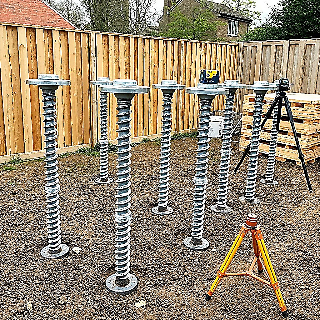 Array of ground screws installed in garden